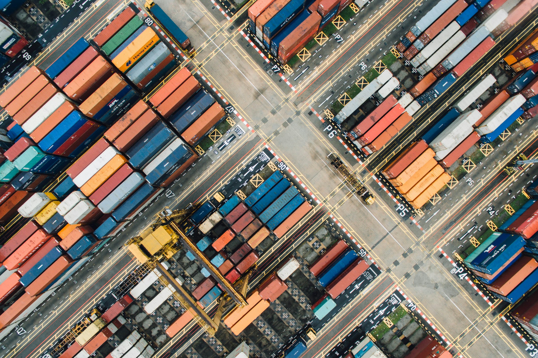 Container vessel at a port with cargo containers and cranes